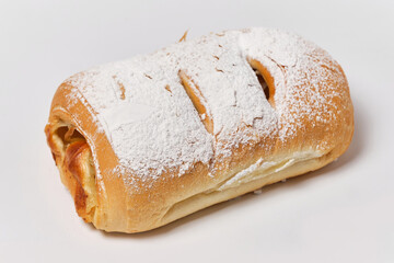 puff with apples and powdered sugar on a white background, close view