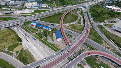 Aerial view of highway and overpass in city on a sunny day.-