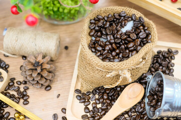 Coffee beans in burlap sack on coffee tree background