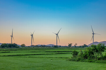 Fototapeta na wymiar Landscape with Turbine Green Energy Electricity, Windmill for electric power production, Wind turbines generating electricity on rice field at Phan Rang, Ninh Thuan, Vietnam. Clean energy concept.