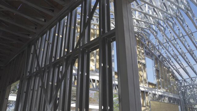 Steel frame method house structure under construction with blue sky at background