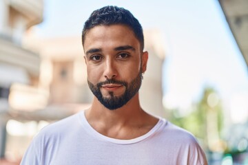 Fototapeta premium Young arab man standing with serious expression at street
