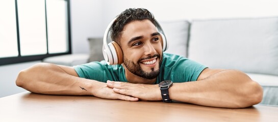 Young arab man smiling confident listening to music at home