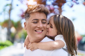 Fototapeta premium Father and daughter smiling confident hugging each other holding on back at park