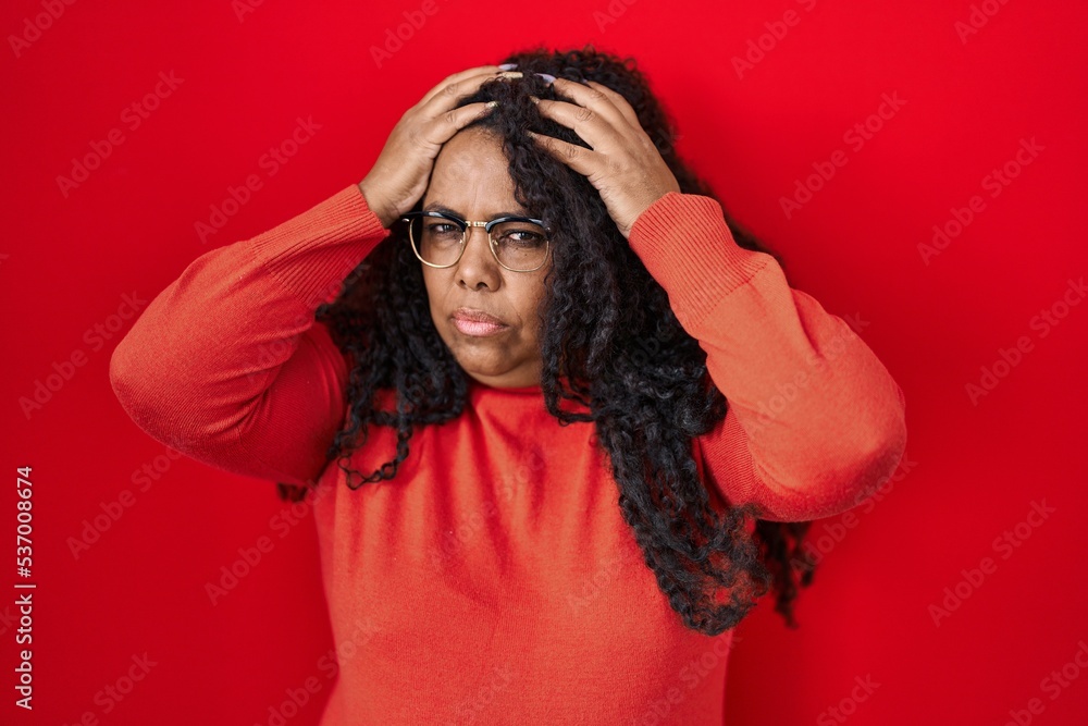 Sticker plus size hispanic woman standing over red background suffering from headache desperate and stressed