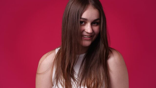 4k crop video of cute caucasian woman smiling isolated over red background.