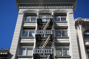 Metalic stairs used for emergency outside a residential building from America. Vintage style staircase architecture.