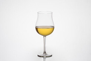 one glass of white wine, tulip glass, oenology, wineries, white background.