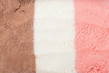 texture of pink, white and chocolate ice cream like background, close up