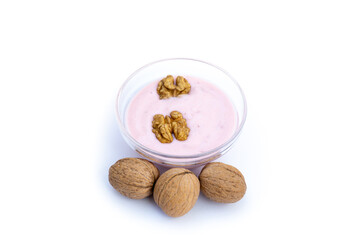 Walnuts and strawberry yoghurt, white background, isolated