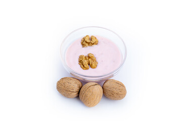 Walnuts and strawberry yoghurt, white background, isolated