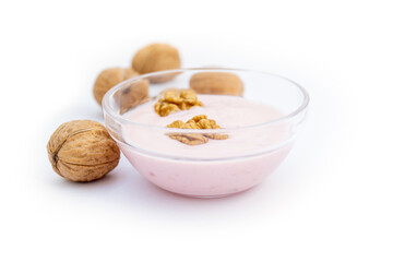 Walnuts and strawberry yoghurt, white background, isolated