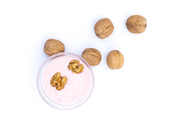 Walnuts and strawberry yoghurt, white background, isolated