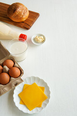 Cheddar cheese with varius ingredient for make sandwich.
