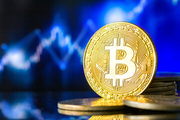  Golden metallic bitcoin on the background of stock charts.Legalization of Bitcoin