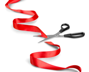 Scissors and red ribbon on a white background