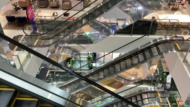 Bangkok, Thailand Monday 10 October 2022 at 14:00 pm People are shopping in a large shopping mall in the middle of the capital city of Thailand.  Use the escalators to go up each floor of the departme