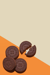 Round chocolate Cookie on multi-colored background. Festive, children's background. Flat lay. Sweet cookies flat lay pattern. Top view.