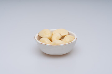 Minced and peeled garlic on a white background