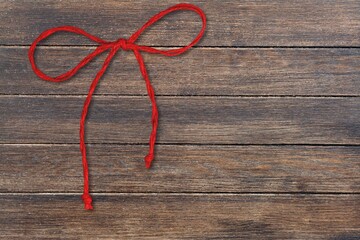 A thread in red color tied in a woolen bow