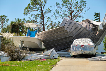Severely damaged by hurricane Ian house and vehicle in Florida mobile home residential area. Consequences of natural disaster