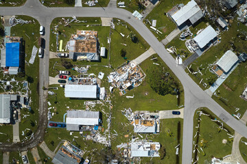 Severely damaged by hurricane Ian houses in Florida mobile home residential area. Consequences of...