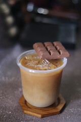 Closeup of Iced Caramel Macchiato at the coffee shop, Caramel Macchiato is a classic macchiato beverage. It consists of vanilla syrup, espresso, steamed milk, foam, and caramel drizzle