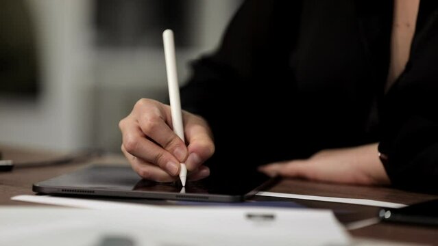 Woman hands with graphic pen on tablet draw