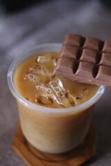 Closeup of Iced Caramel Macchiato at the coffee shop, Caramel Macchiato is a classic macchiato beverage. It consists of vanilla syrup, espresso, steamed milk, foam, and caramel drizzle
