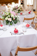 Fototapeta na wymiar Beautiful wedding decoration. Banquet table setting and decoration. Flower decoration of wedding tables. Cutlery on the table.