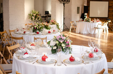 Beautiful wedding decoration. Banquet table setting and decoration. Flower decoration of wedding tables. Cutlery on the table.