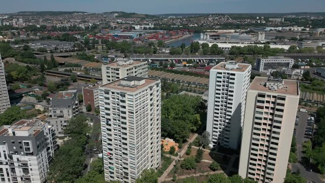 Modern condominiums in Parisian suburb, Paris in France. Aerial backward tilt up reveal