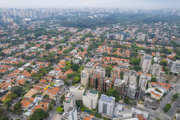 Rainy day in the Jardins neighborhood located in the city of São Paulo, capital. Dark clouds, buildings, cars, trees and pedestrians circling.