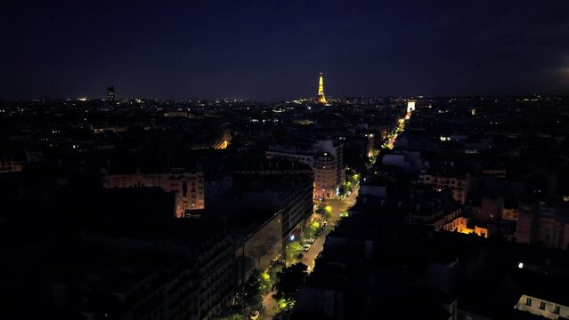 Paris skyline at night, France. Aerial drone rising. Sky for copy space