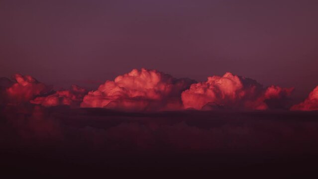Clouds at sunset. Incredible colors of the sky at sunset. Timelapse of clouds moving across the sky. Clouds float across the sky in sunset rays. Beautiful white clouds in accelerated view mode