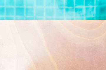Obraz premium Sandstone swimming pool table, natural sand stone texture with blue swimming pool tile background