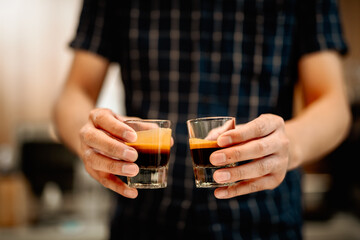 Asian Barista  making Coffee with coffee machine in the coffee shop. people with barista in cafe concept.