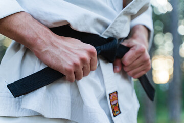 A young man doing karate in the forest training strength pose meditation  © Dusan