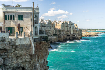 Fototapeta na wymiar Spectacular houses of the old town of Polignano a Mare built on the cliffs above the Adriatic Sea view from the sea on a beautiful sunny day