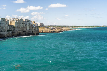 Spectacular houses of the old town of Polignano a Mare built on the cliffs above the Adriatic Sea view from the sea on a beautiful sunny day