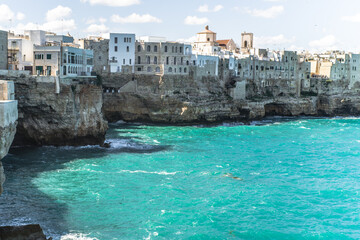 Spectacular houses of the old town of Polignano a Mare built on the cliffs above the Adriatic Sea view from the sea on a beautiful sunny day