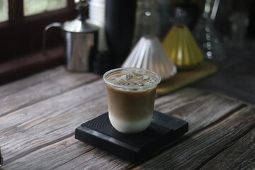 Closeup of Iced Caramel Macchiato at the coffee shop, Caramel Macchiato is a classic macchiato beverage. It consists of vanilla syrup, espresso, steamed milk, foam, and caramel drizzle