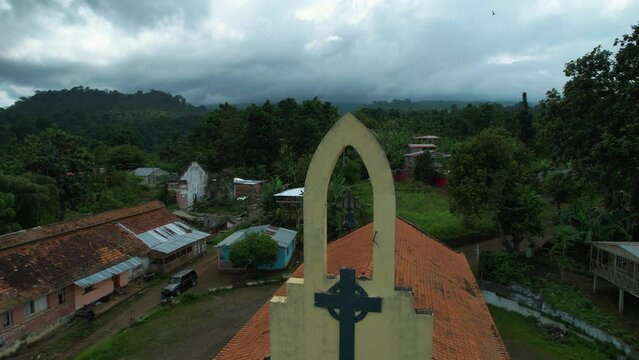 Aerial view around the church bell on the cathedral of Roça Agostinho Neto, Sao Tome - orbit, drone shot