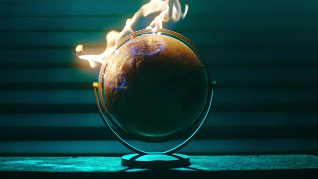 terrestrial globe spinning and on fire, global warming