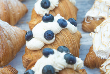 Cream cheese croissant decorated with fresh blueberries. - 537037093