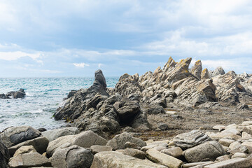 basalt rocks on the sea coast, Cape Stolbchaty on Kunashir Island