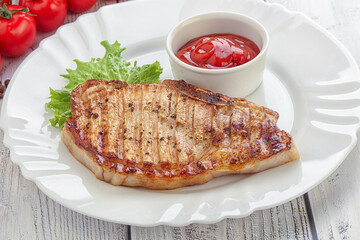 Grilled pork steak with ketchup