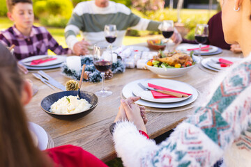 Caucasian family spending time together outside and praying before meal