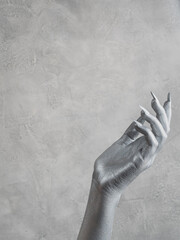 Woman’s hand with silver skin. Cosmetology, beauty industry