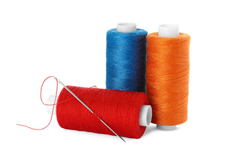 Different colorful sewing threads and needle on white background